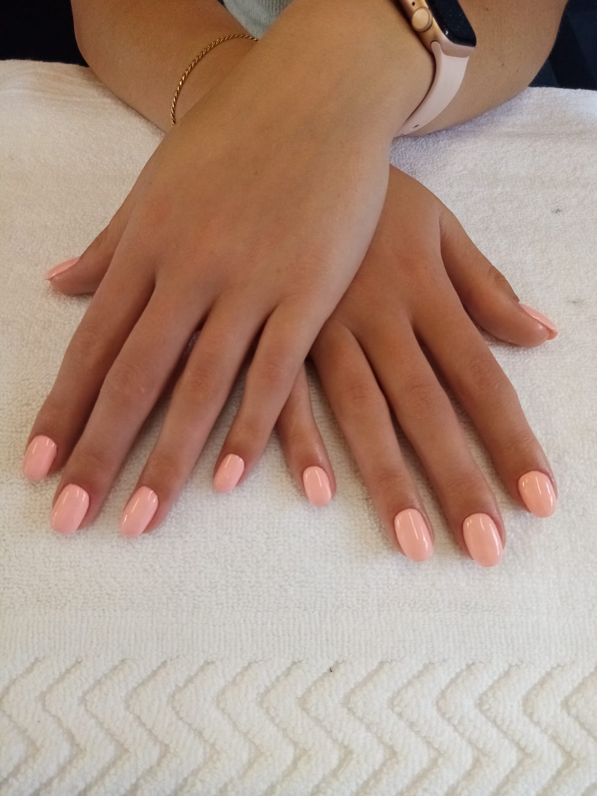 A close up of a woman 's hands with pink nails