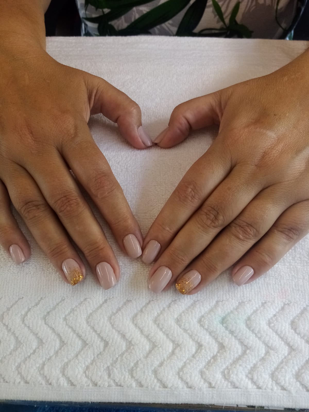 A woman is making a heart shape with her hands