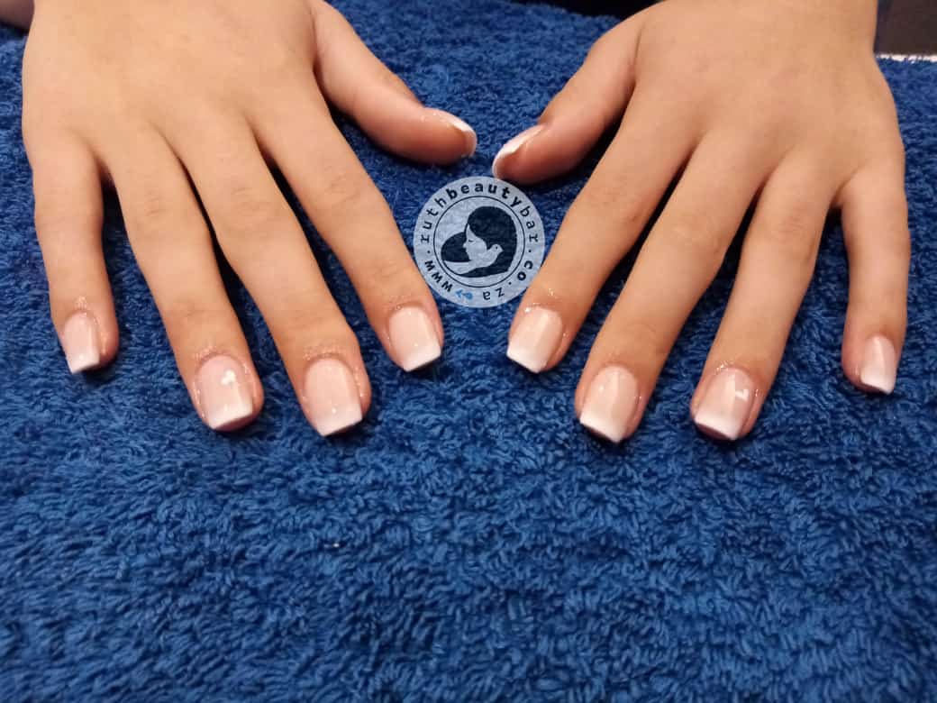 A close up of a woman 's nails on a blue towel