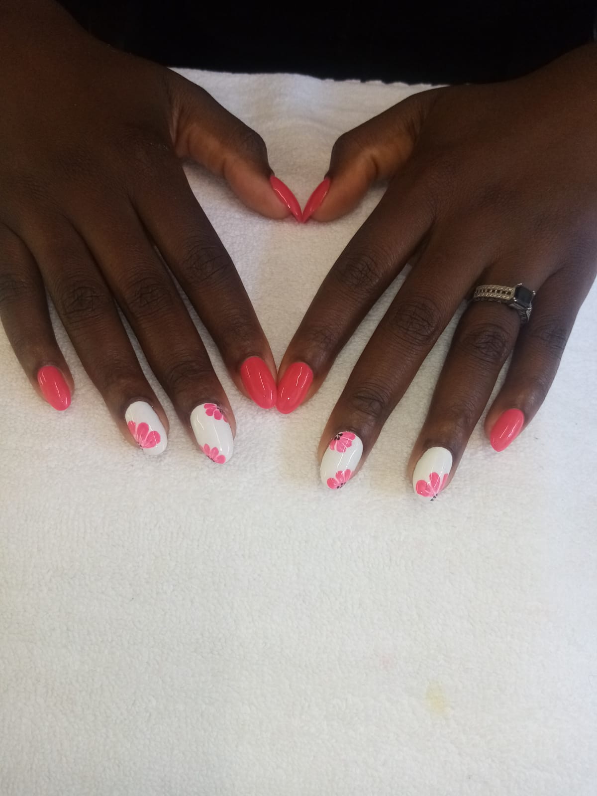 A close up of a woman 's hands with pink and white nails