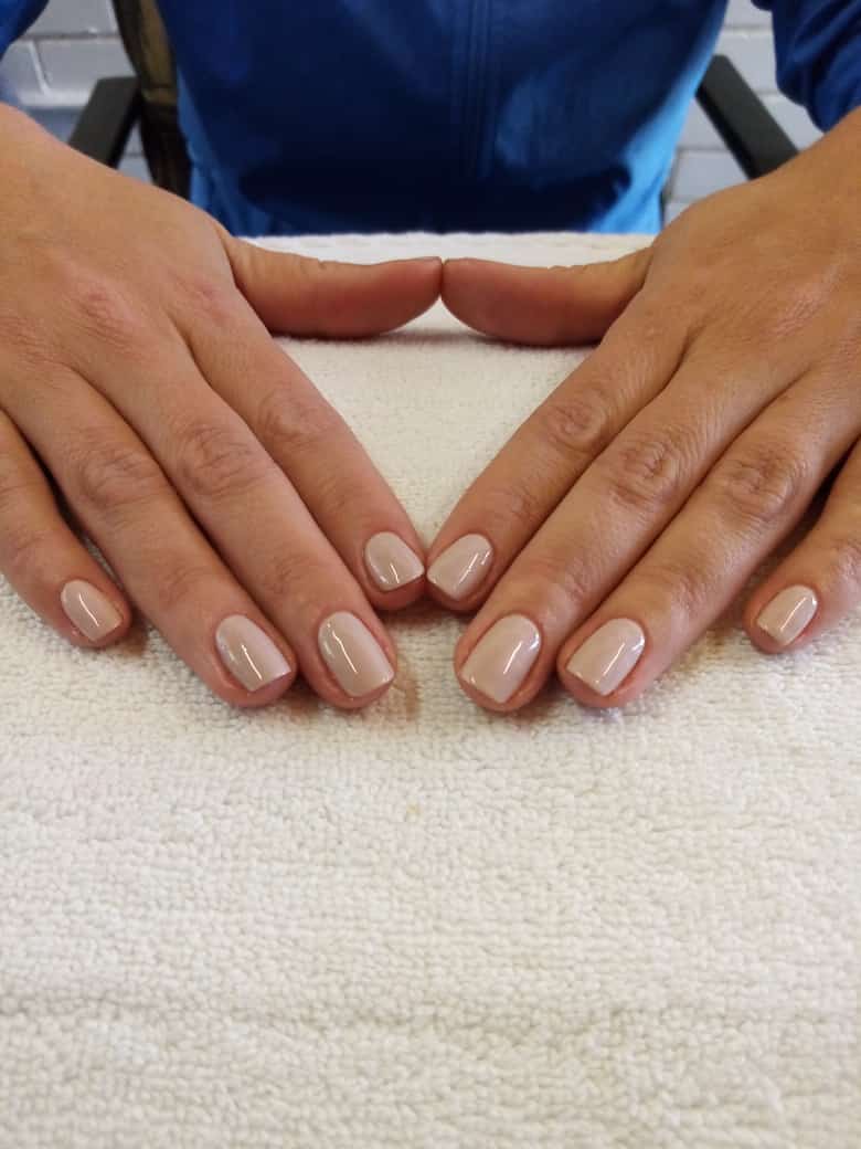 A woman 's hands are folded over a white towel