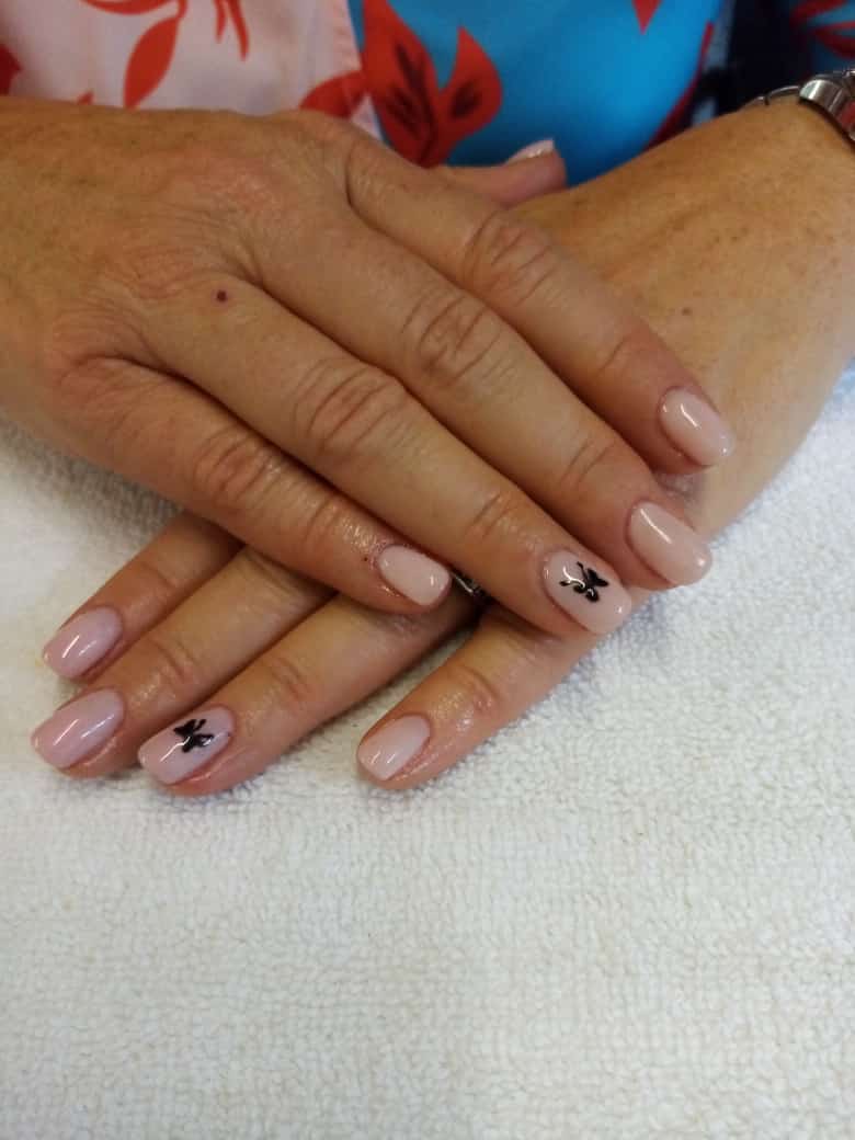 A close up of a woman 's nails with a butterfly design