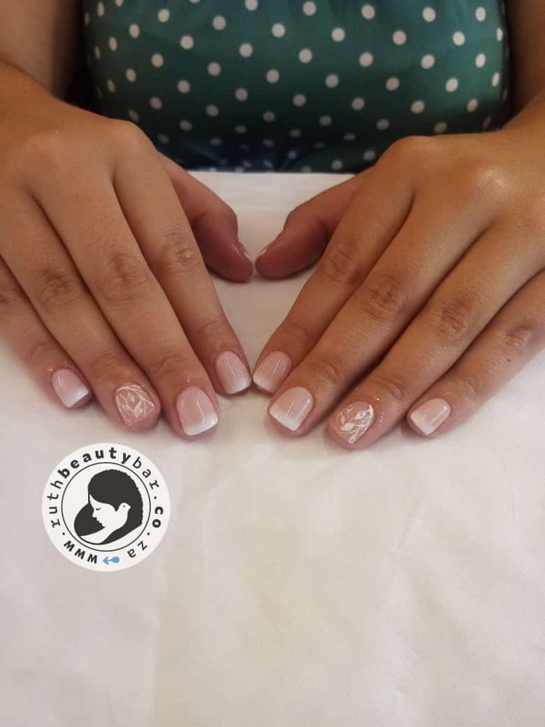 A close up of a woman 's nails with a logo in the corner