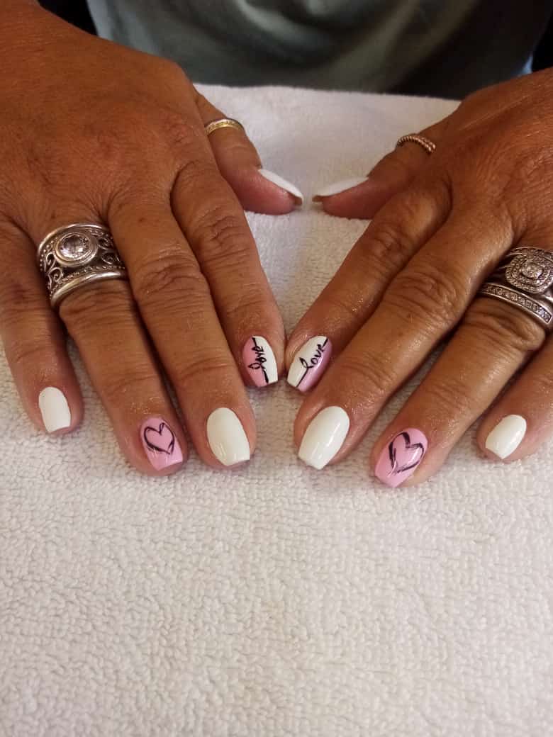 A close up of a woman 's nails with rings on them