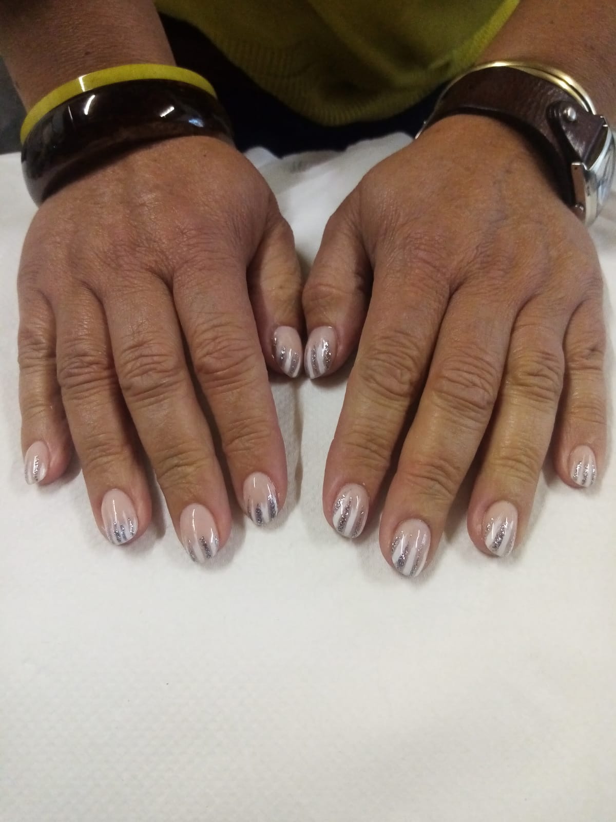 A close up of a person 's hands with their nails painted