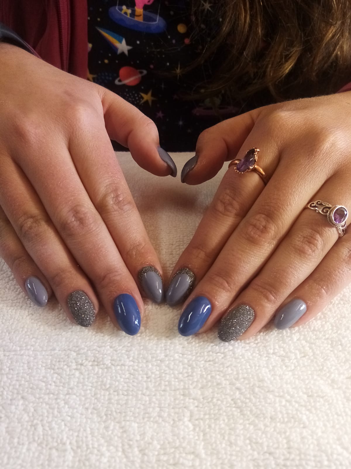 A close up of a woman 's hands with rings on them