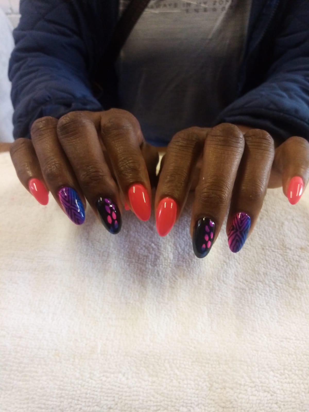A close up of a woman 's nails with different colors
