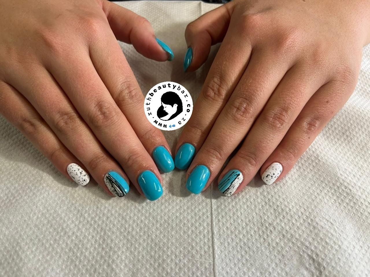 A close up of a woman 's hands with blue and white nails