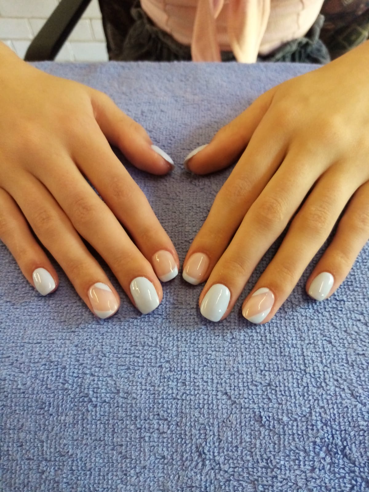 A close up of a woman 's nails on a blue towel