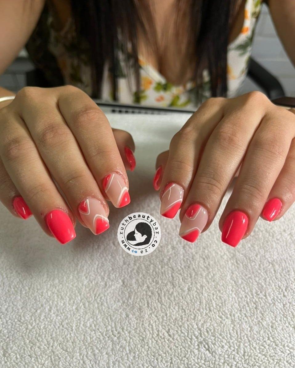 A woman with red nails is sitting on a white towel.
