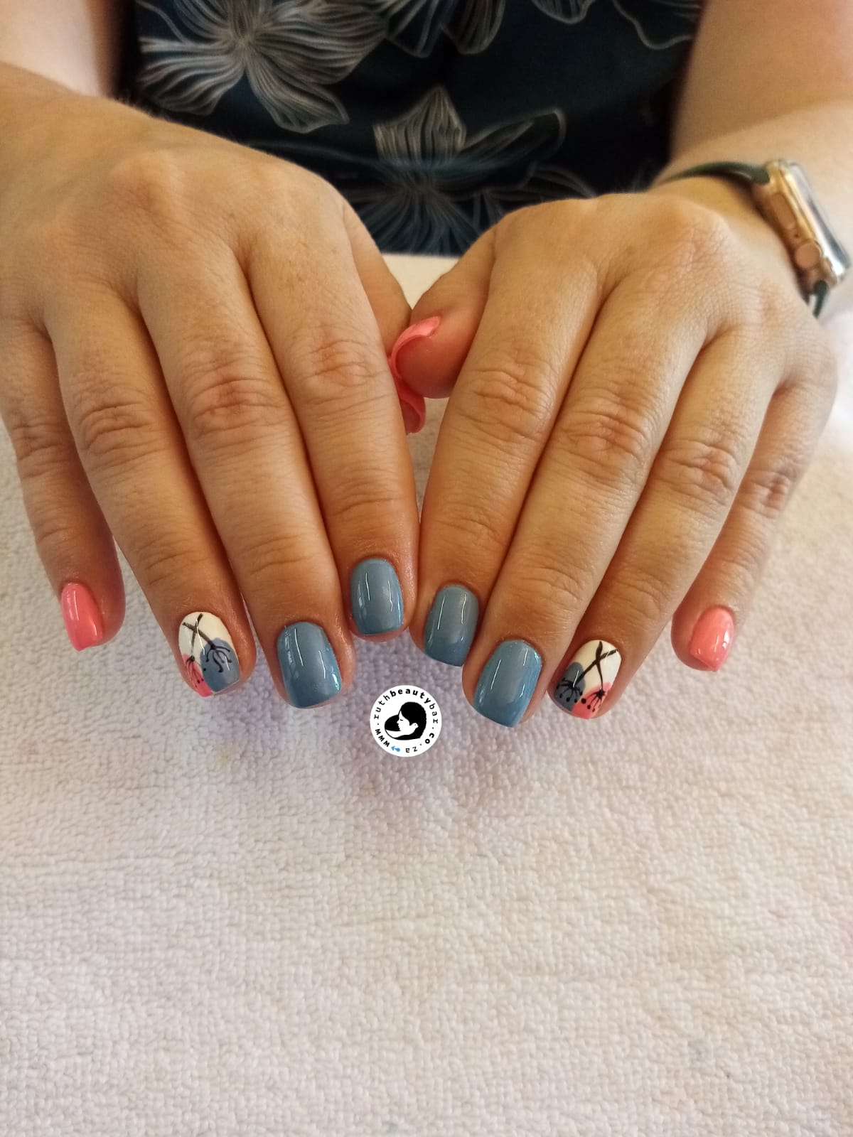 A close up of a woman 's nails on a table.