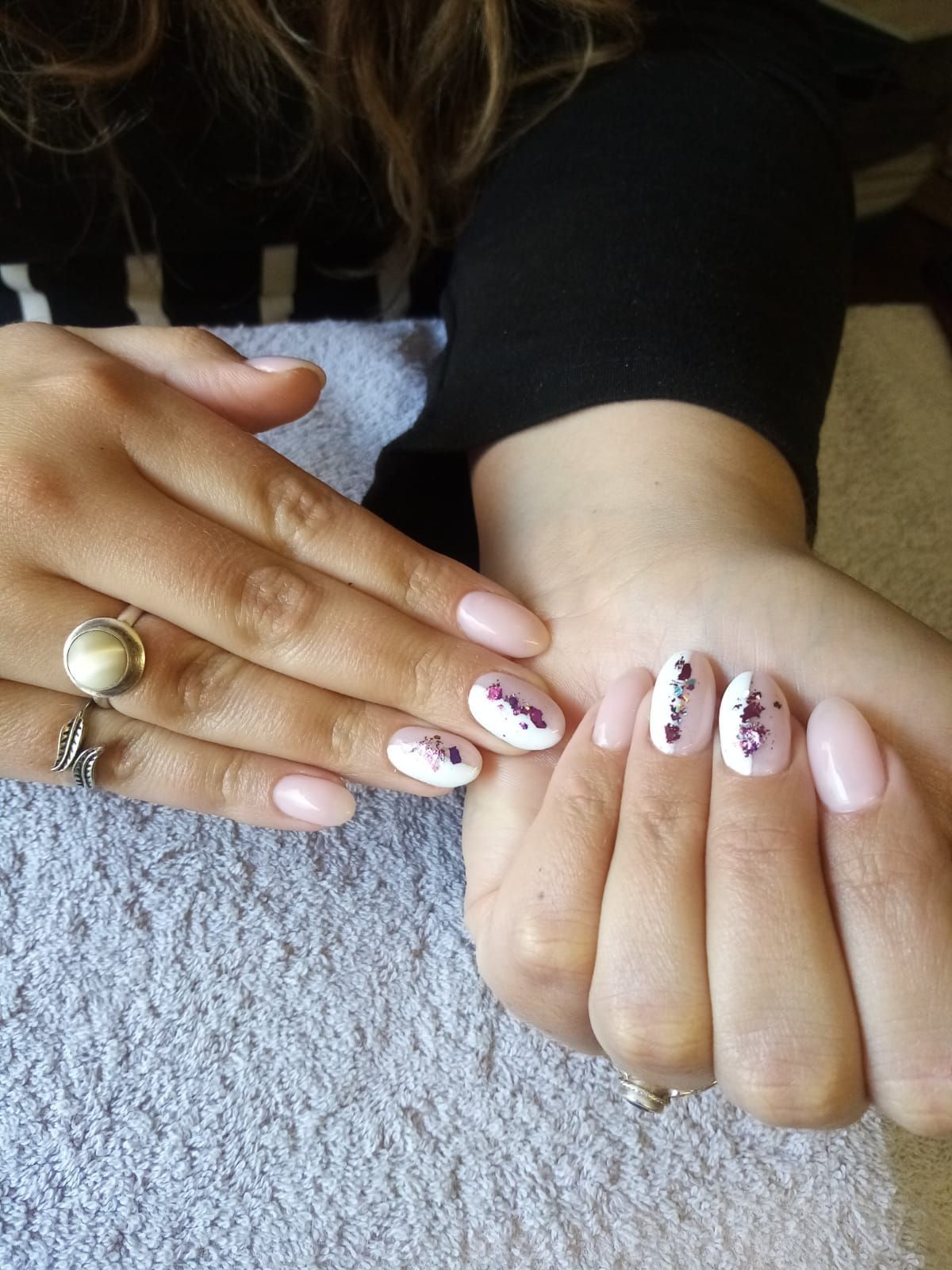 A close up of a woman 's nails with a ring on her finger