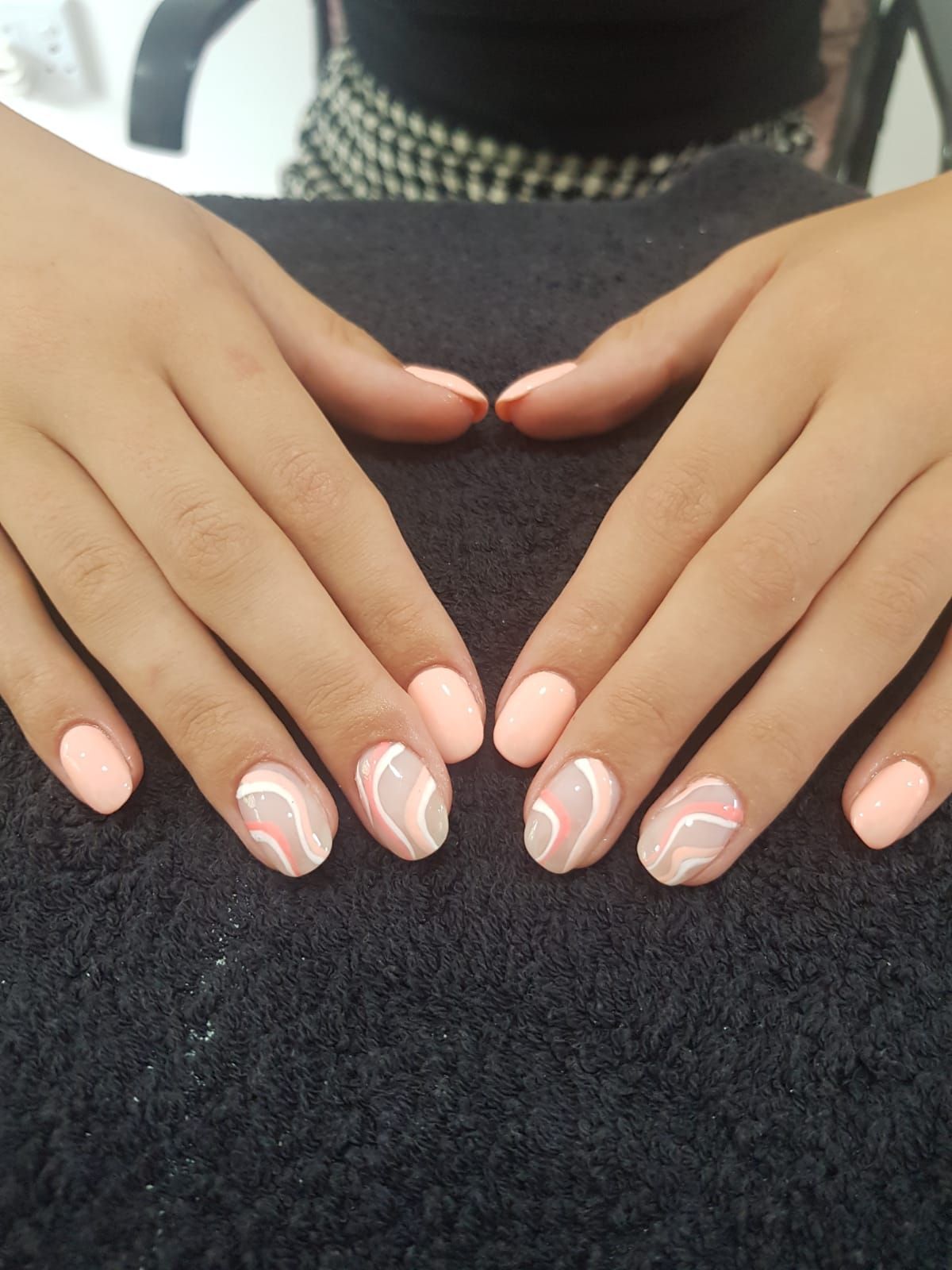 A woman 's hands are making a heart shape with their nails.