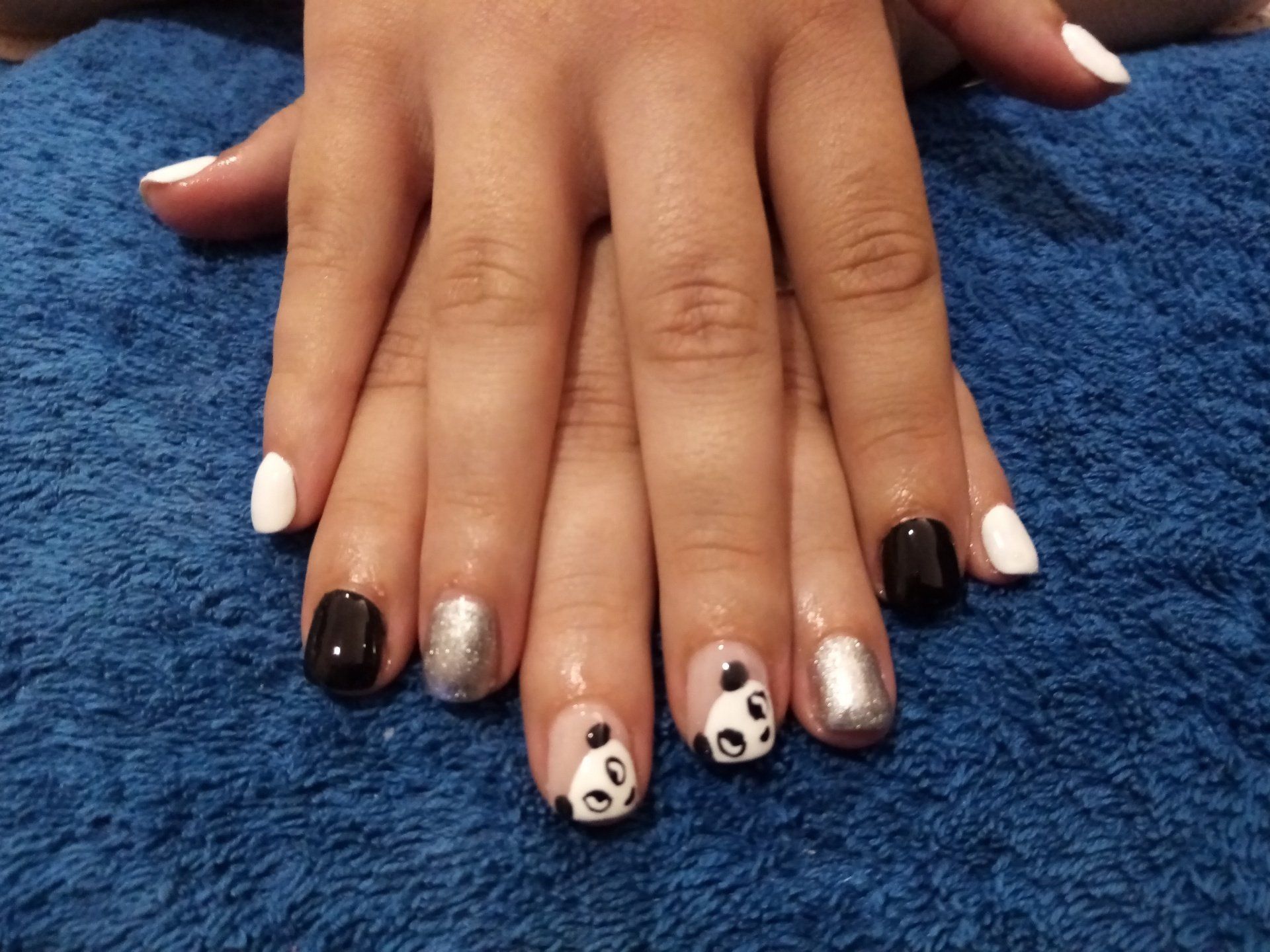 A close up of a person 's nails with a panda design