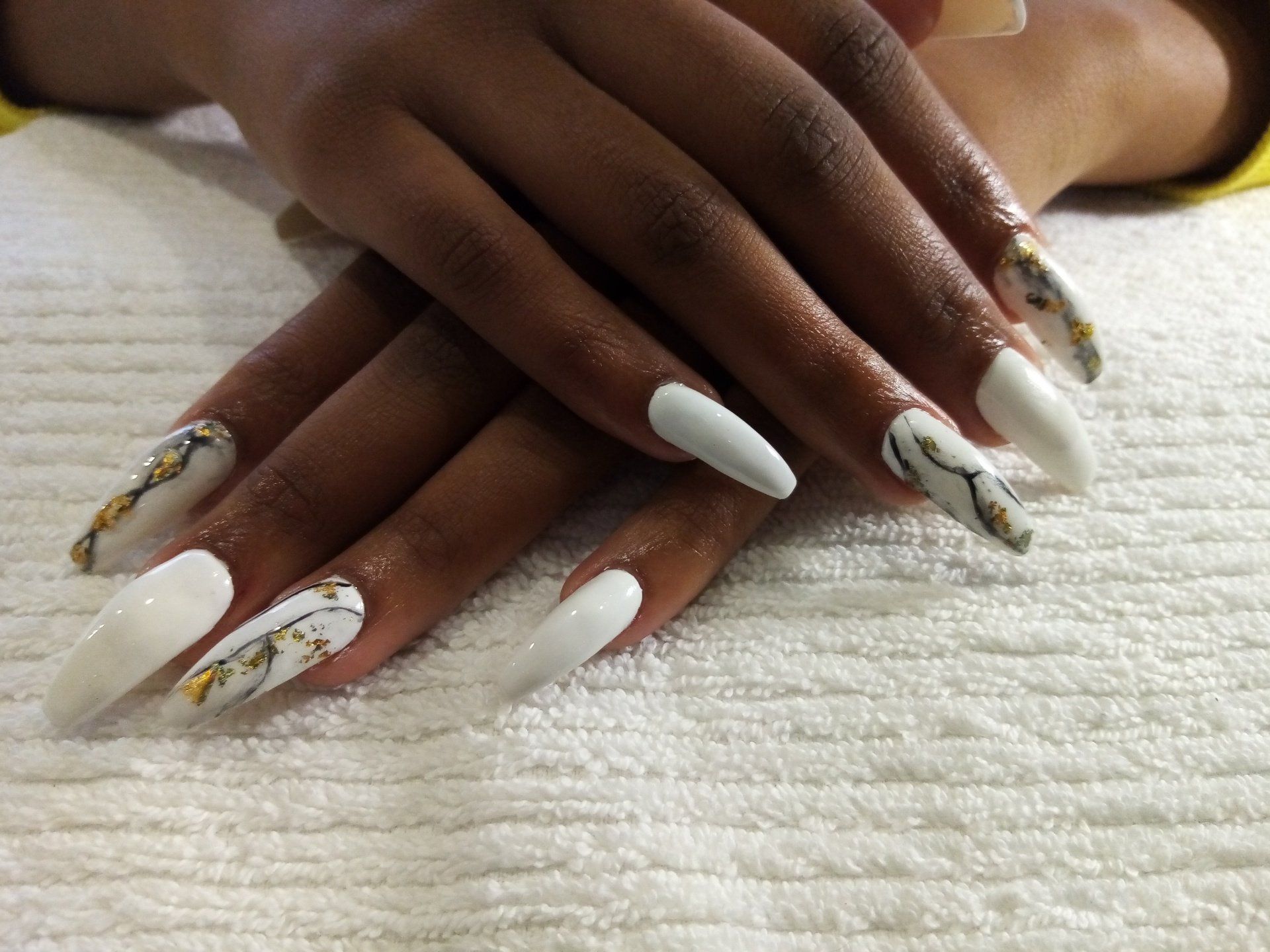 A close up of a woman 's nails on a white towel