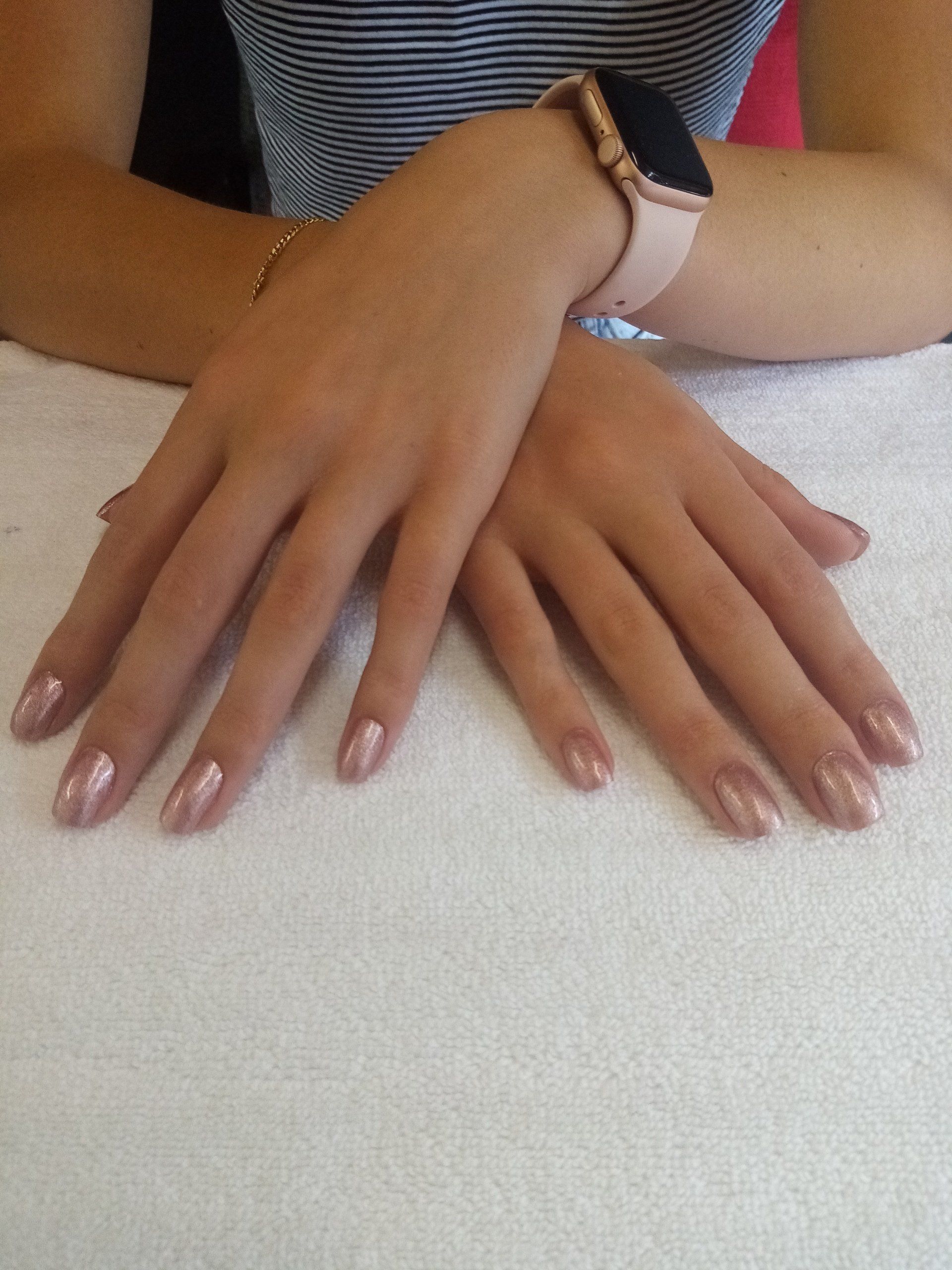 A woman 's hands with a watch on her wrist