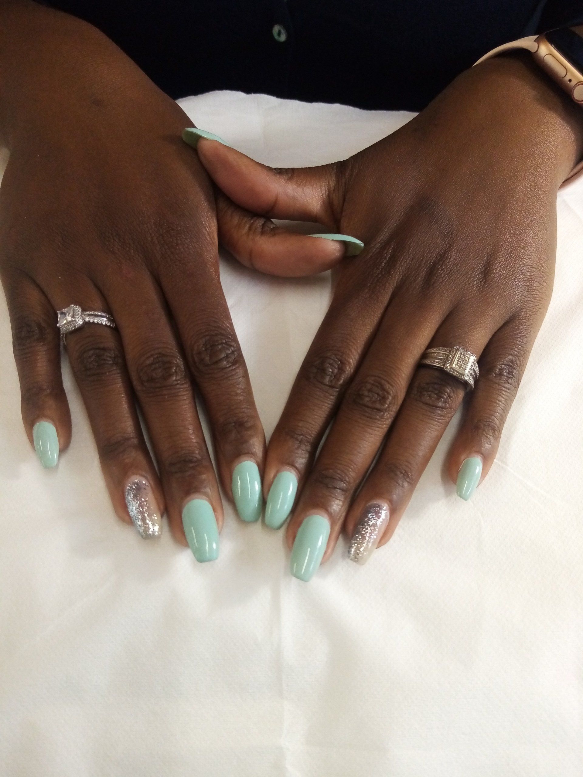 A close up of a woman 's hands with rings on them