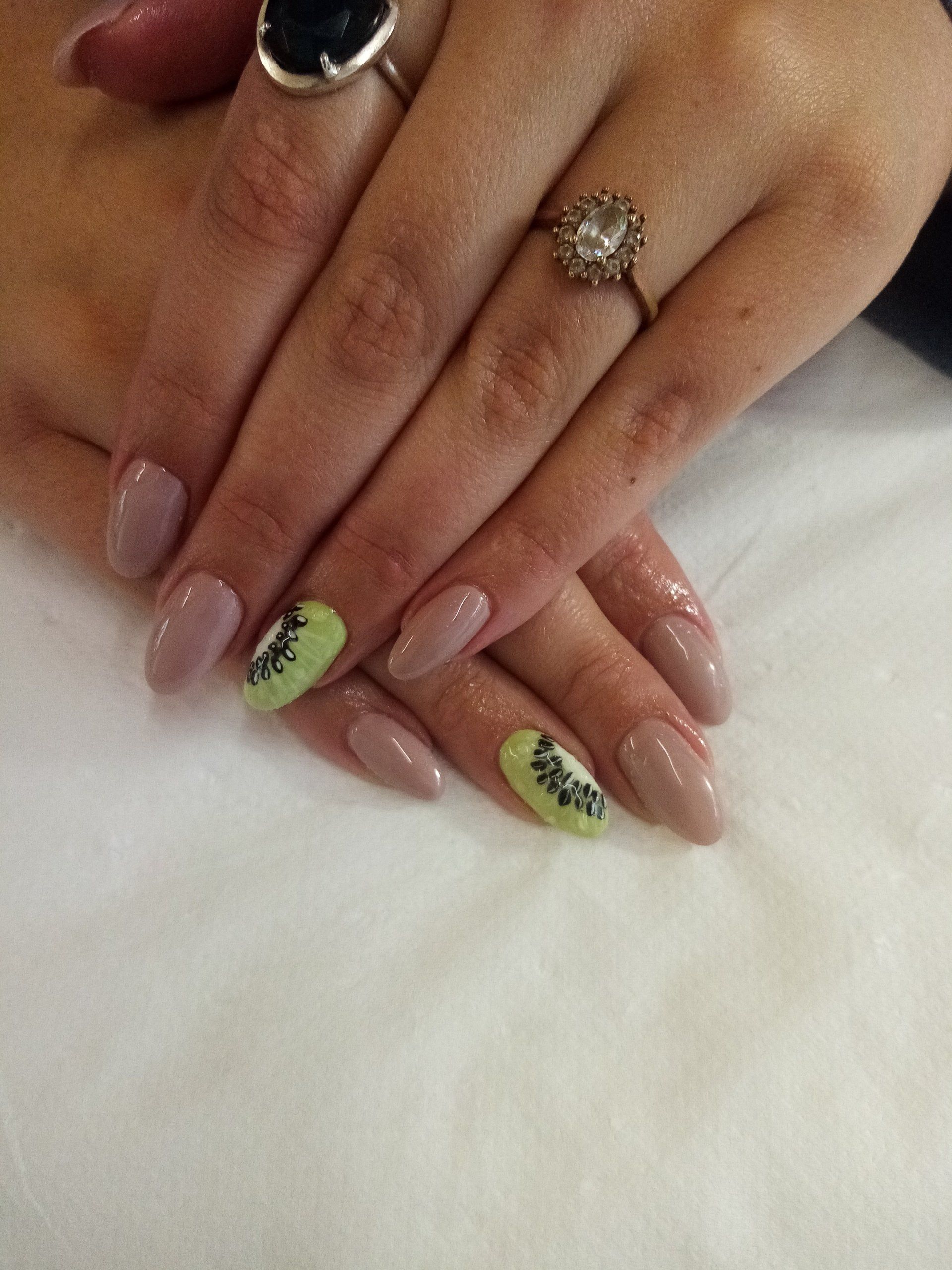 A close up of a woman 's nails with a ring on her finger