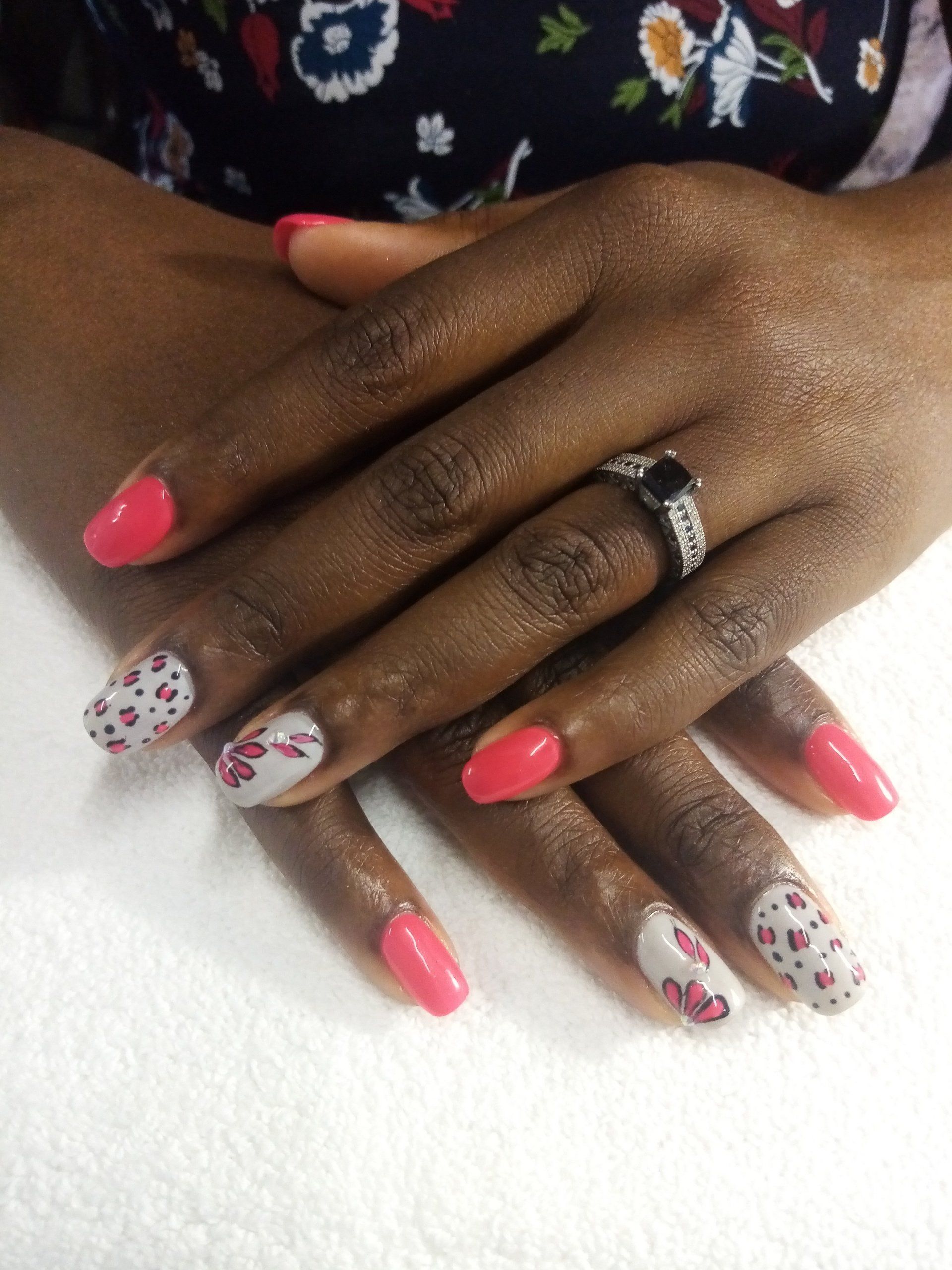 A close up of a woman 's hands with pink and white nails
