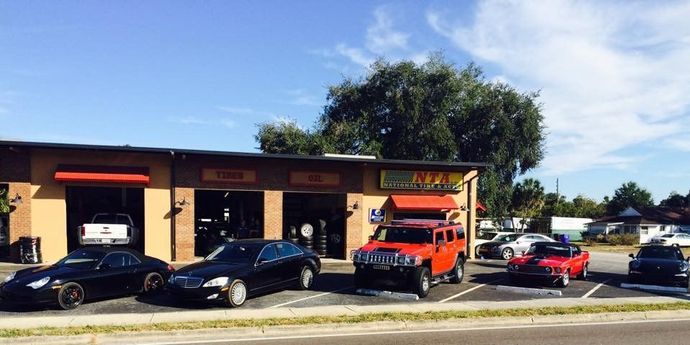 A row of cars are parked in front of a garage