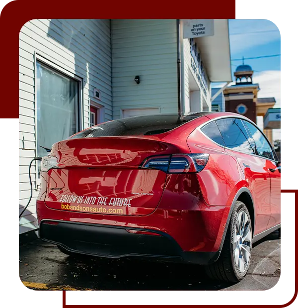 red tesla charging | Bob and Sons Automotive