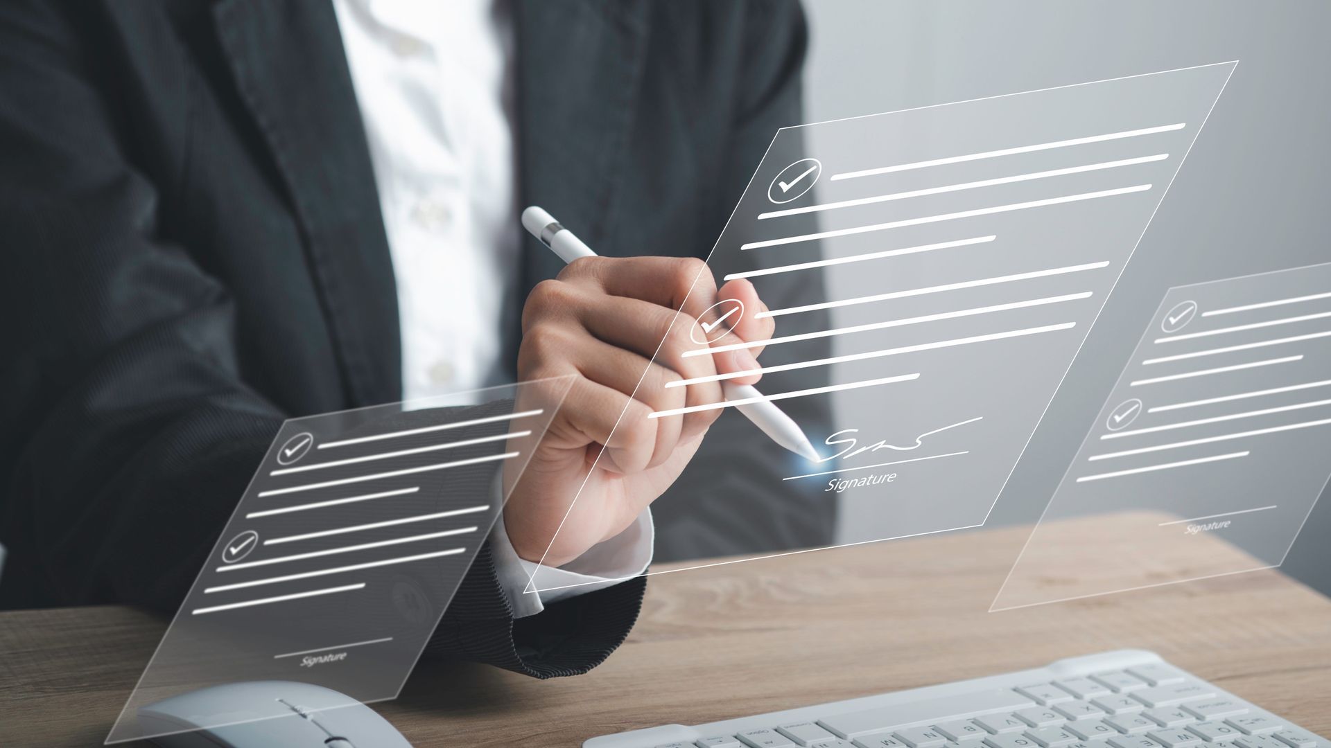 a man is sitting at a desk holding a pen and writing on a hologram
