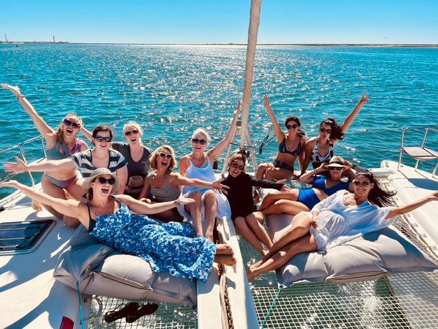 A group of women are sitting on a boat in the ocean.
