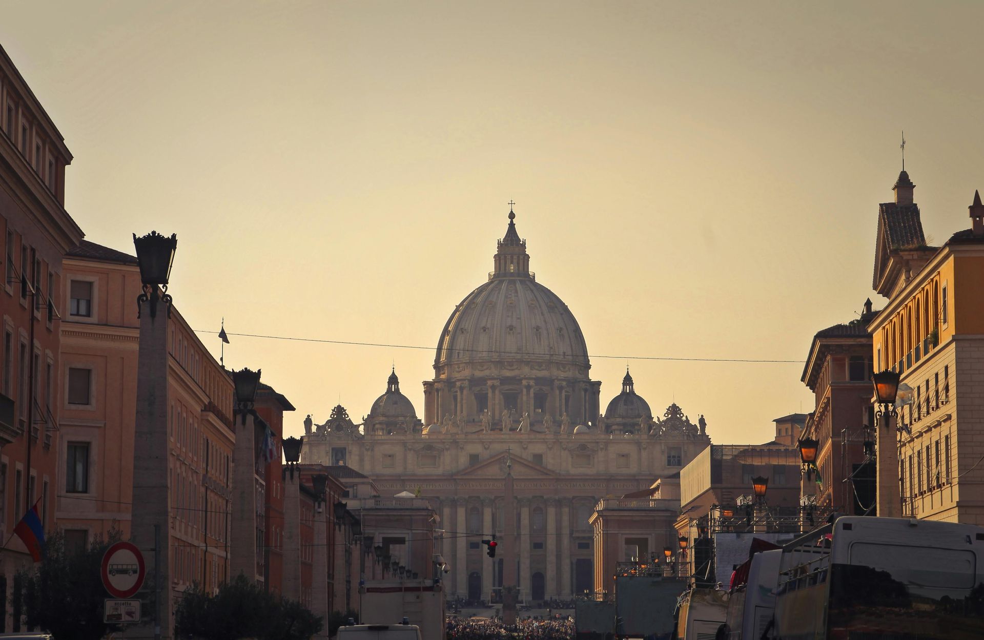 A city street with a large dome in the background