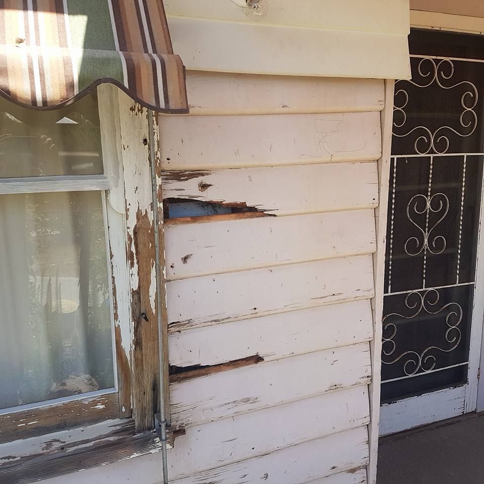 A White House With A Window And A Striped Awning – Horsham, VIC - ALK Property Maintenance