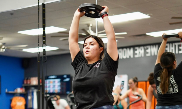 Woman Lifting Weight Plate