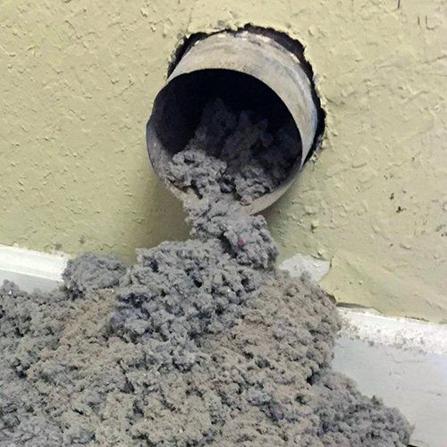 A pipe with a lot of dust coming out of it.