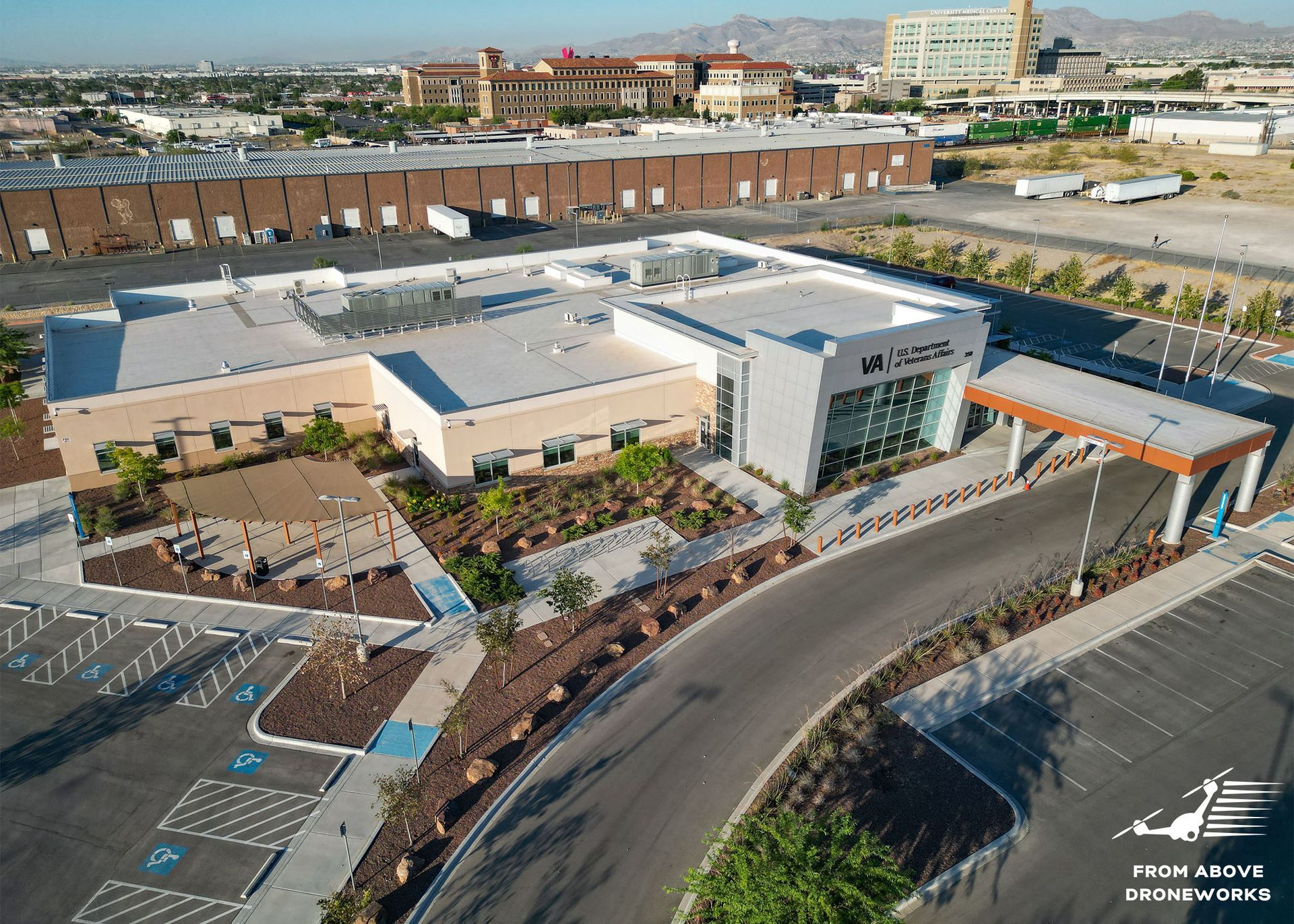 An aerial view of a large building with a parking lot in front of it.