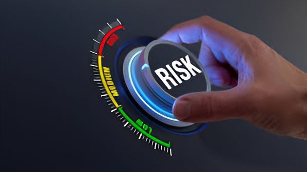 A person is pressing a button with the word risk on it.