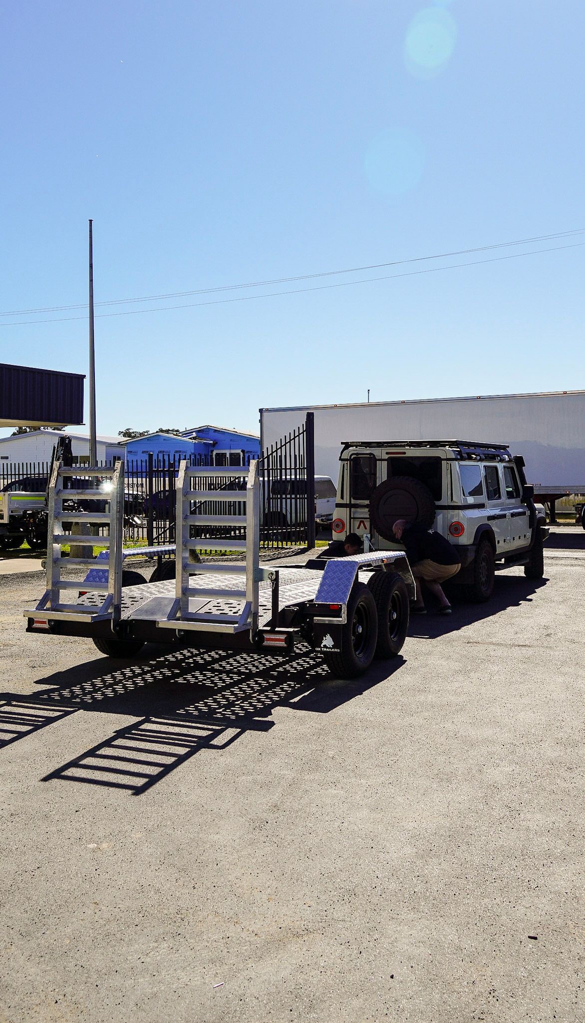 3.5t pro series plant trailer towed by a Granadier for equipment transport at an industrial yard.