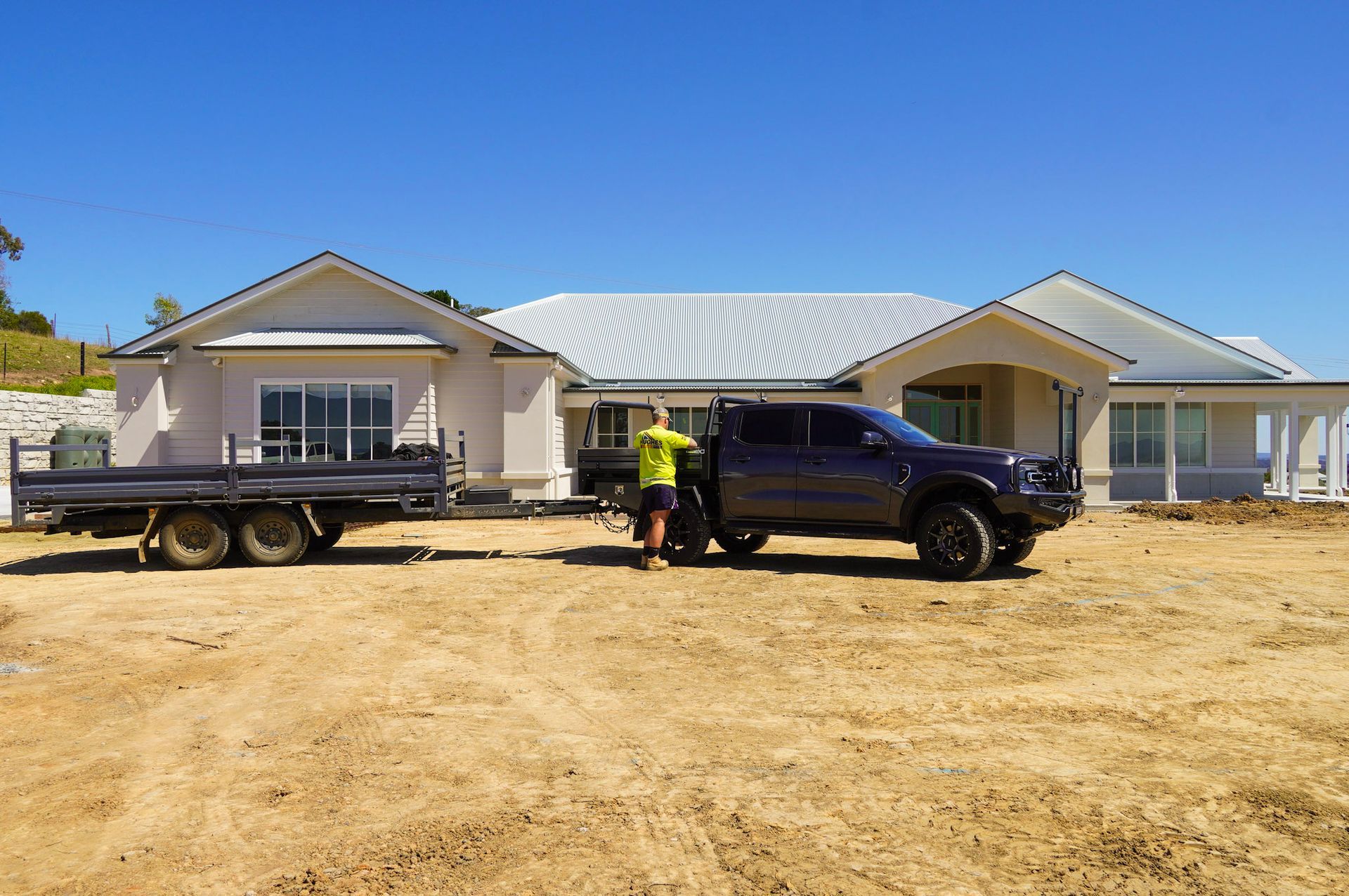 Mark Hughes with his 4.2m Rear Tipper trailer at a construction site.