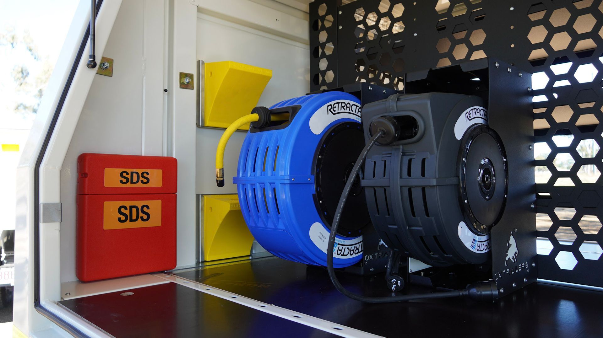 SDS station, wheel chocks, air reels fitted internally into custom service trailer for wasco energy by Ox Trailers,