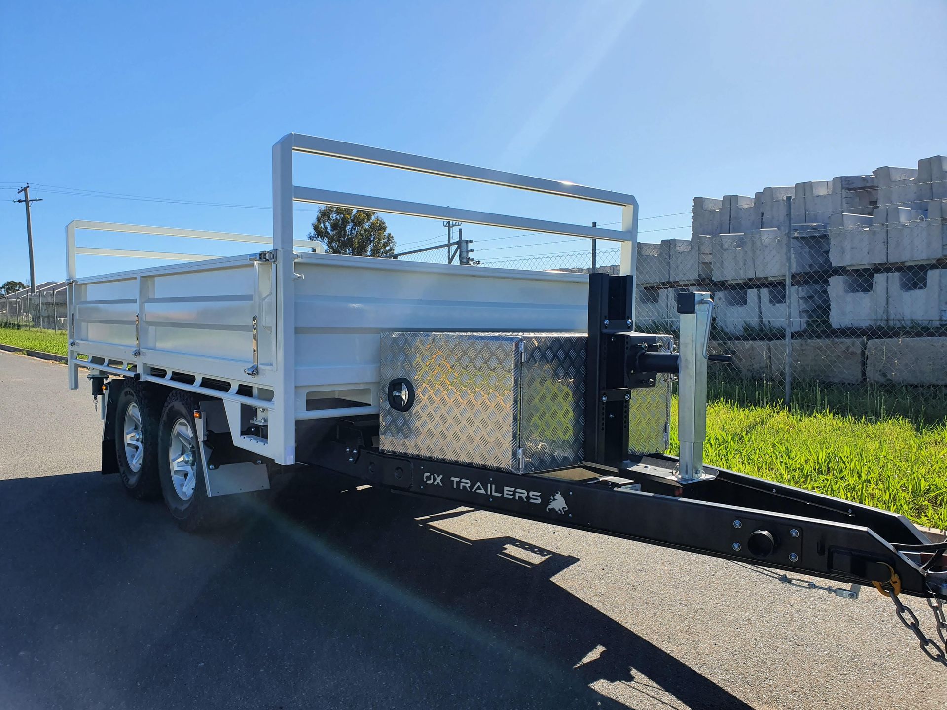 A 3.5m tipper trailer with extender dropsides and a drawbar toolbox on a gravel road.