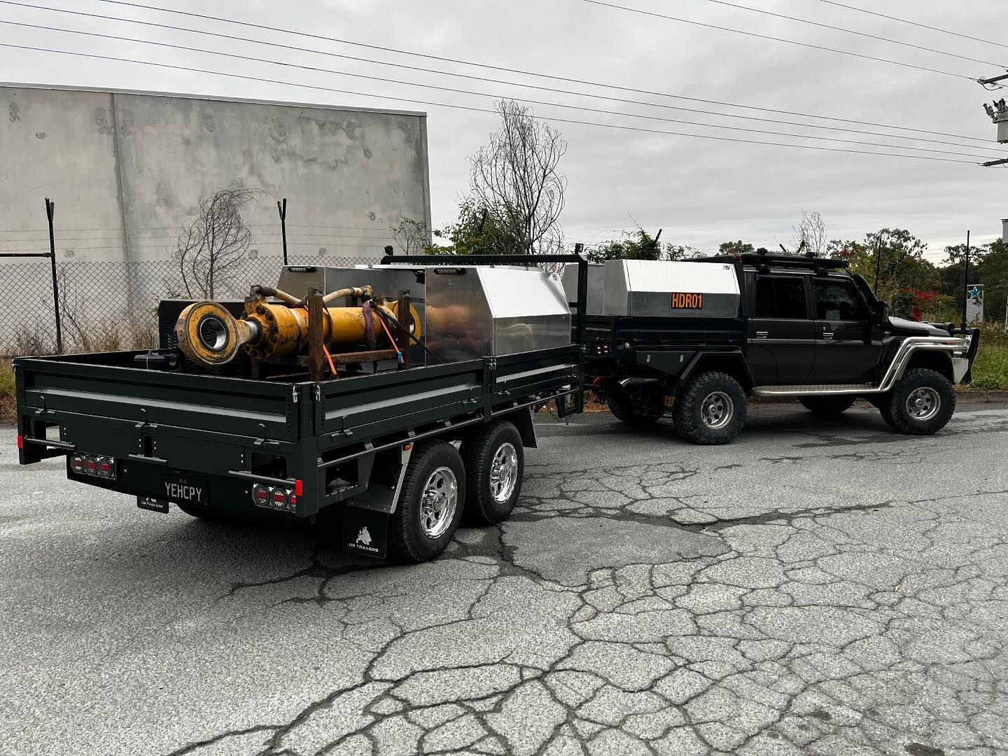 Daniel Henri's trailer with his LandCruiser, both coloured Graphite Landcruiser IG3