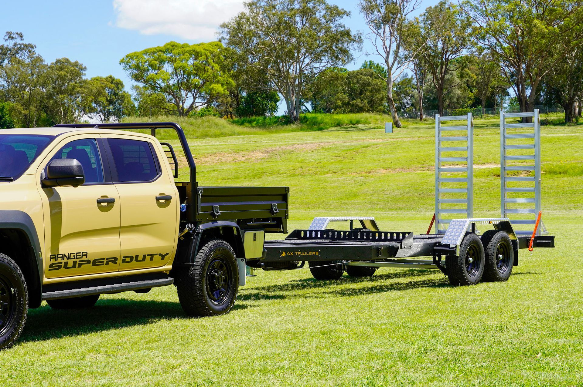 A heavy duty plant trailer delivering an excavator to a construction site.