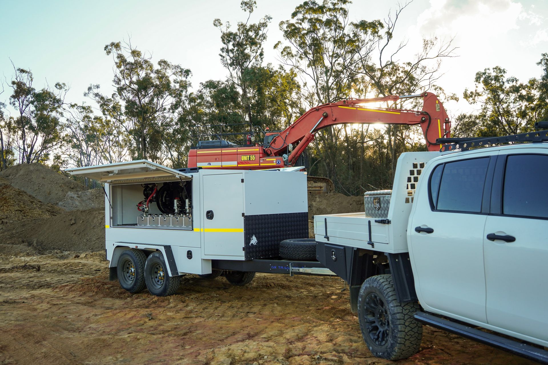 An Ox Service Trailer providing fuel to a large excavator in a quarry.
