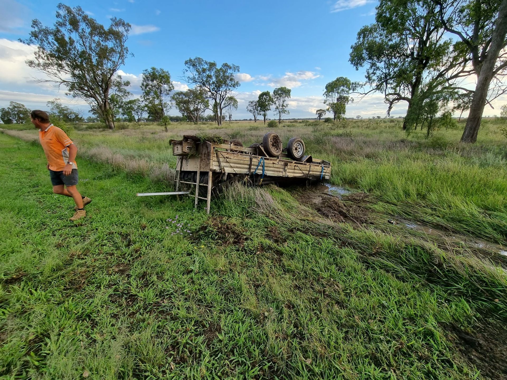 An upside down trailer broken on the side of the road, having flipped with a full load when RHS Chassis snapped.