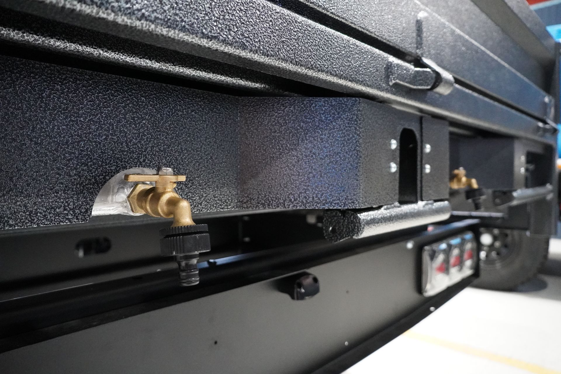 Two Aluminium Undertray water tanks installed on the rear of a flat top trailer.