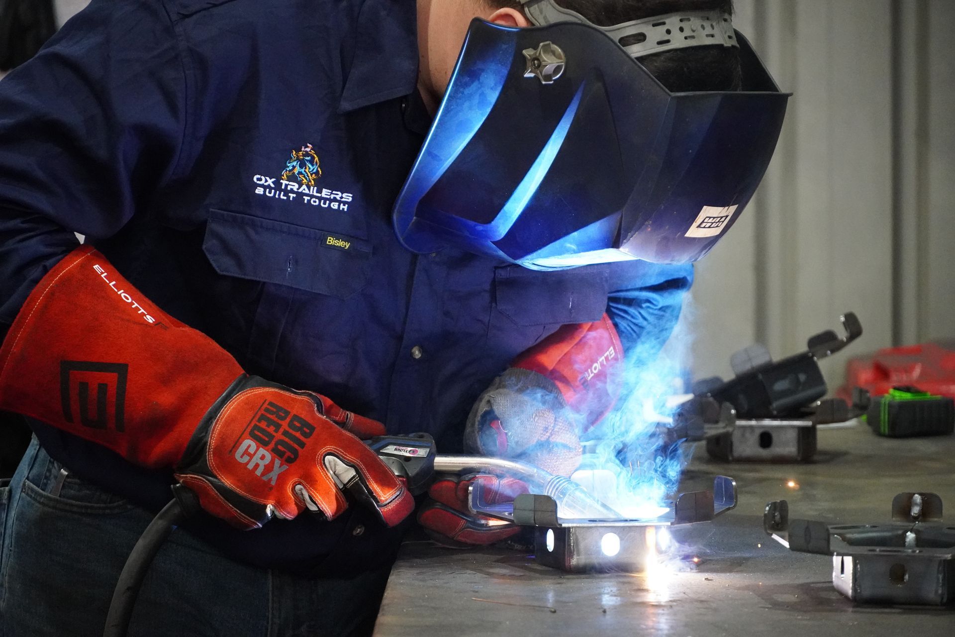 An ox trailer qualified welder welding the spare wheel holder of a plant trailer. 