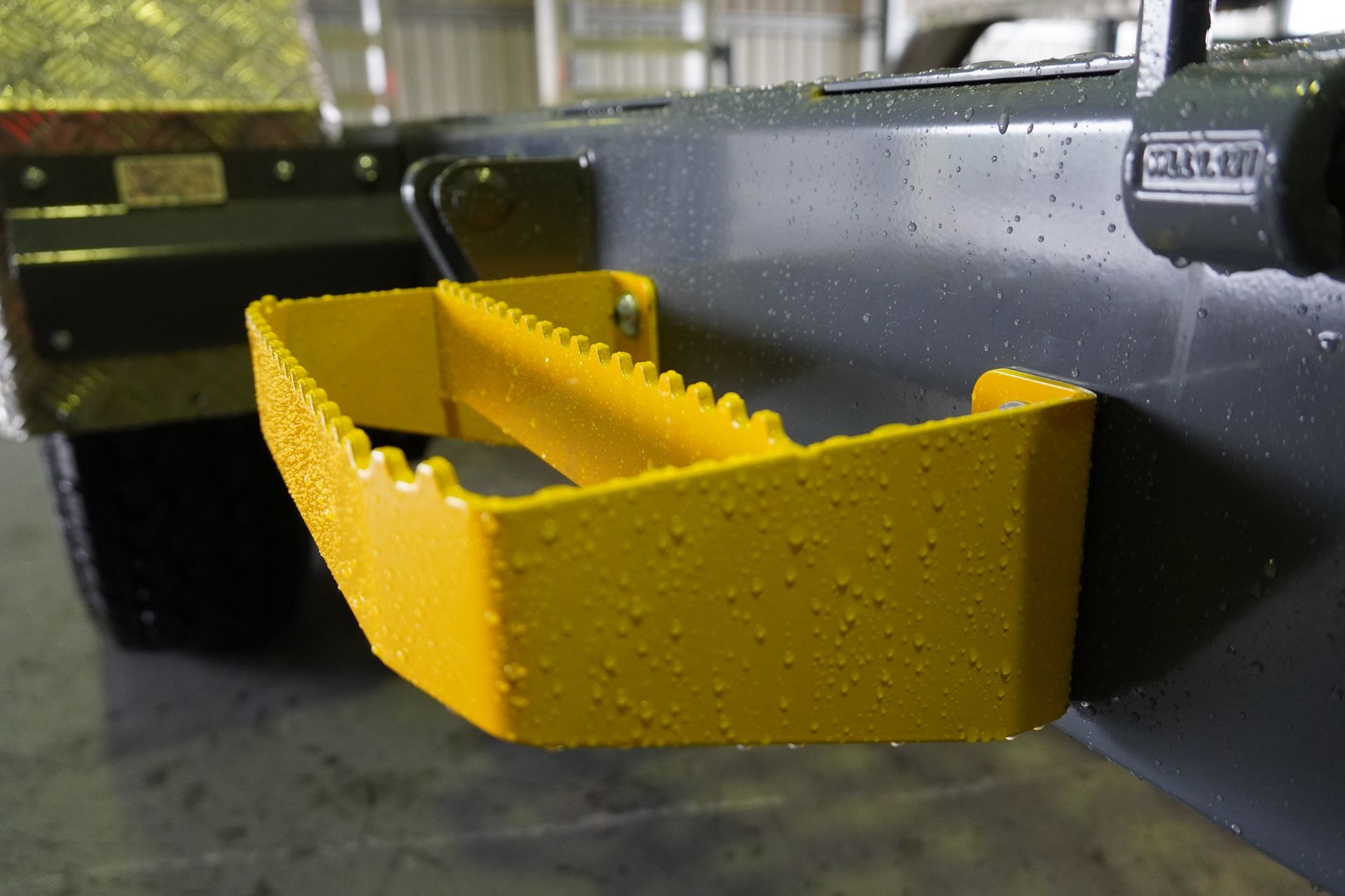 Bright yellow side steps attached to Ox Plant Trailer