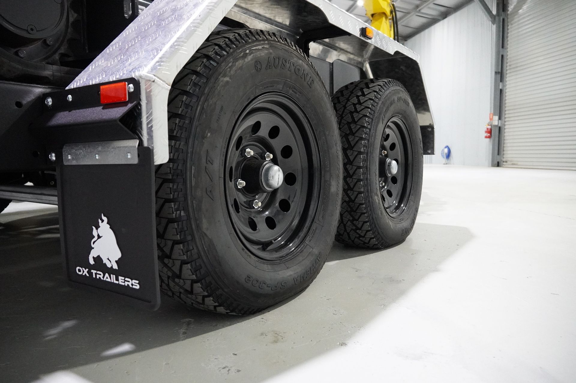 Rear view of plant trailer showing ramps, mudguards and chain storage.
