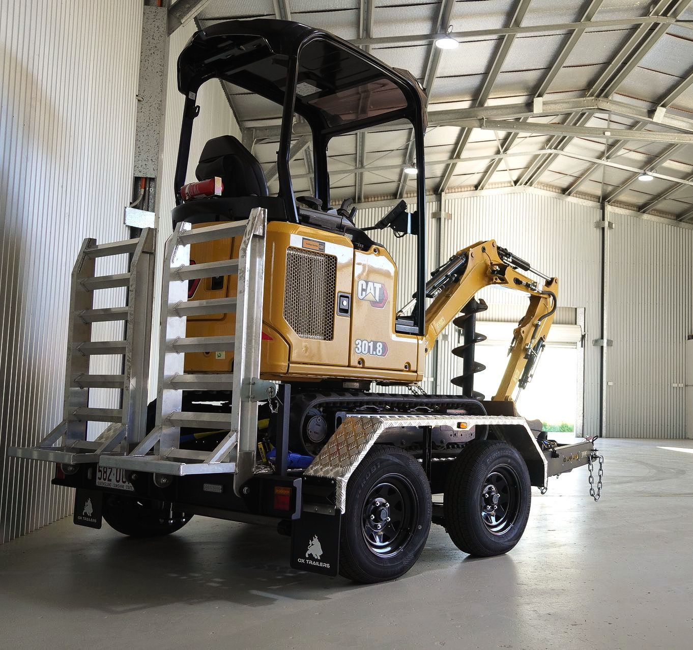 Plant trailer with excavator at construction site. Heavy Duty Plant trailer at construction site.