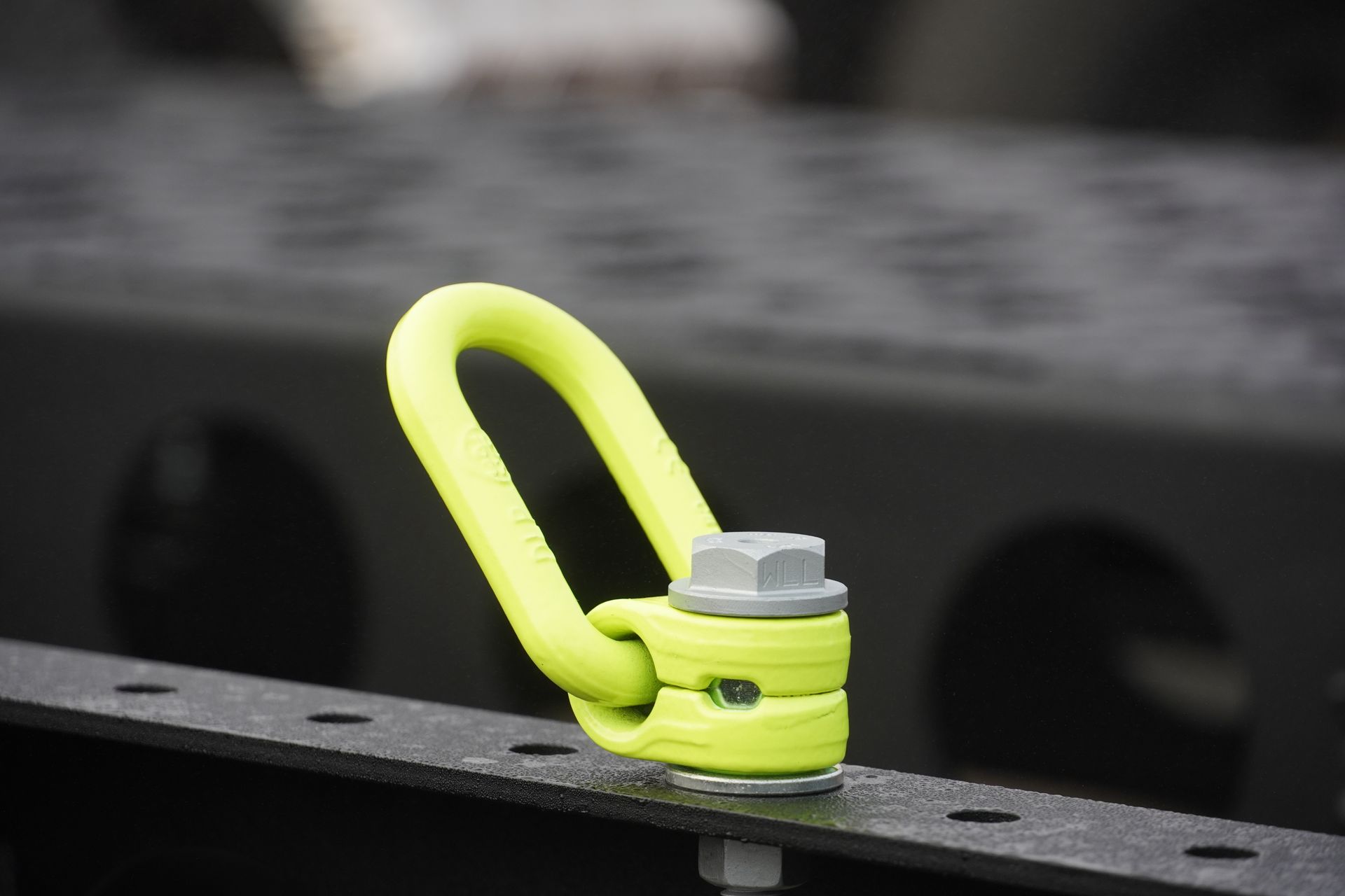 One of the ten bright yellow tie-down points of the King of Spades Excavation rear tipper trailer.