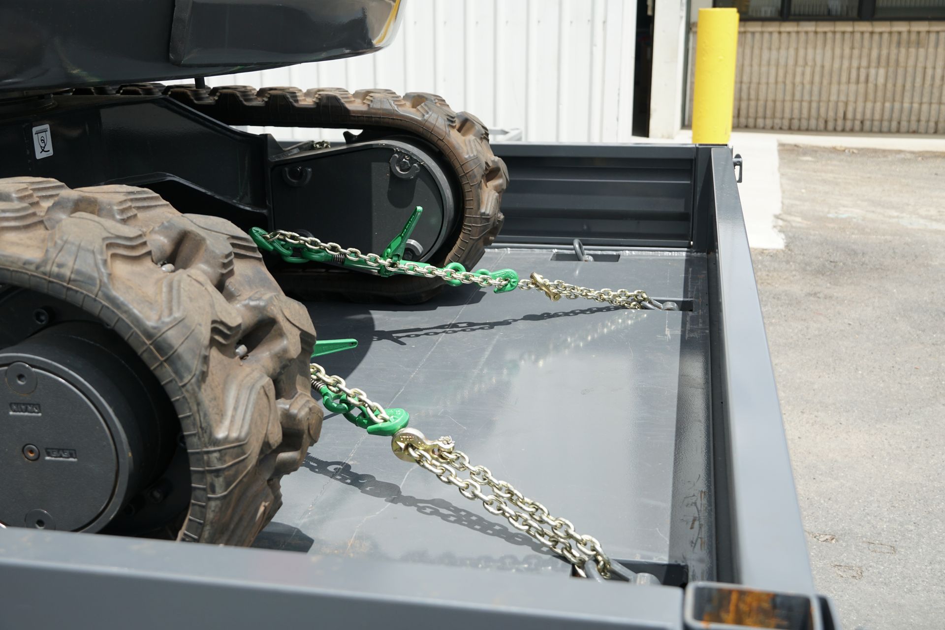 Michael Bruton's tipping trailer with an excavator secured using internal tie-down points.