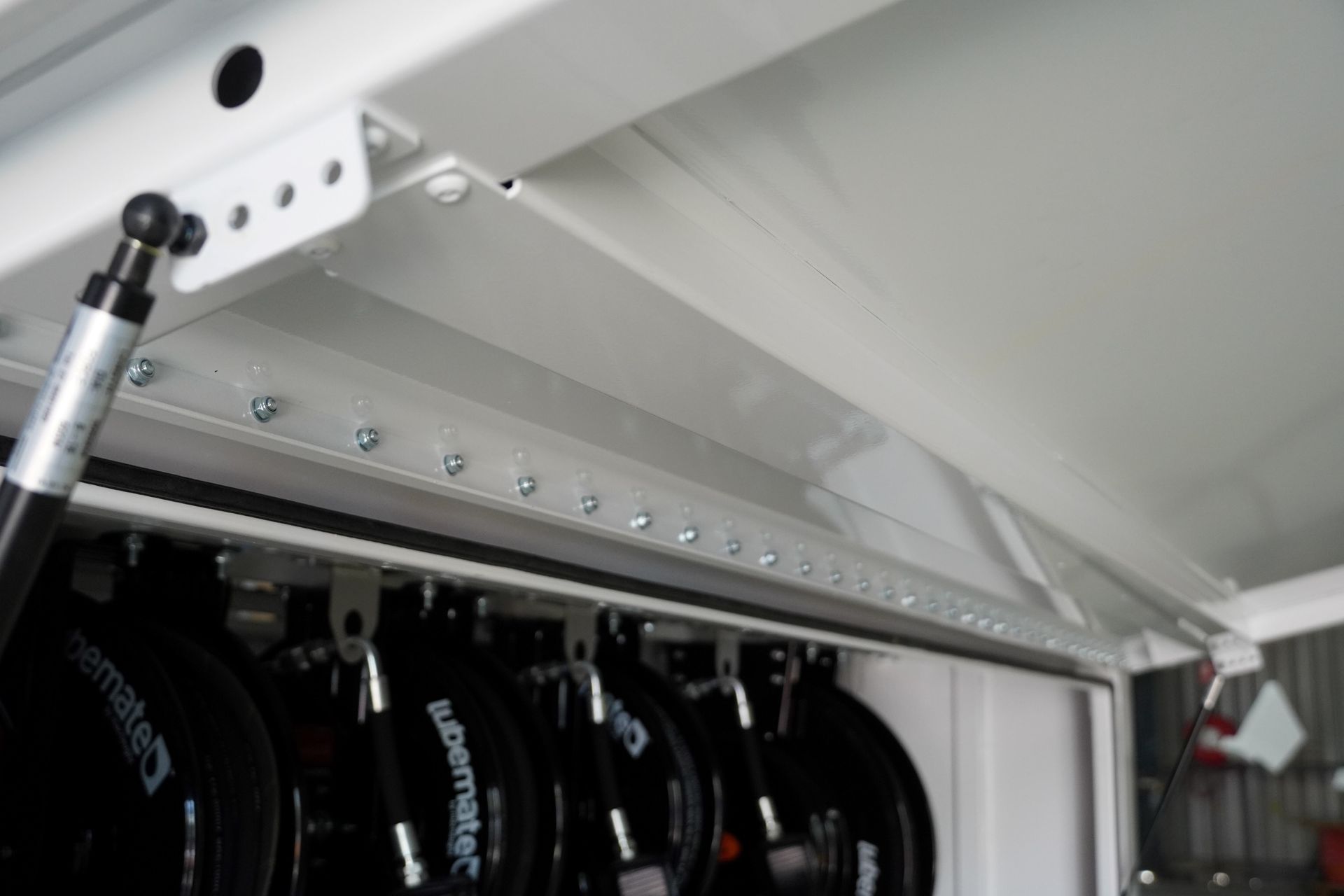 The fasteners and rivets along the full length of the builder's trailer side door.