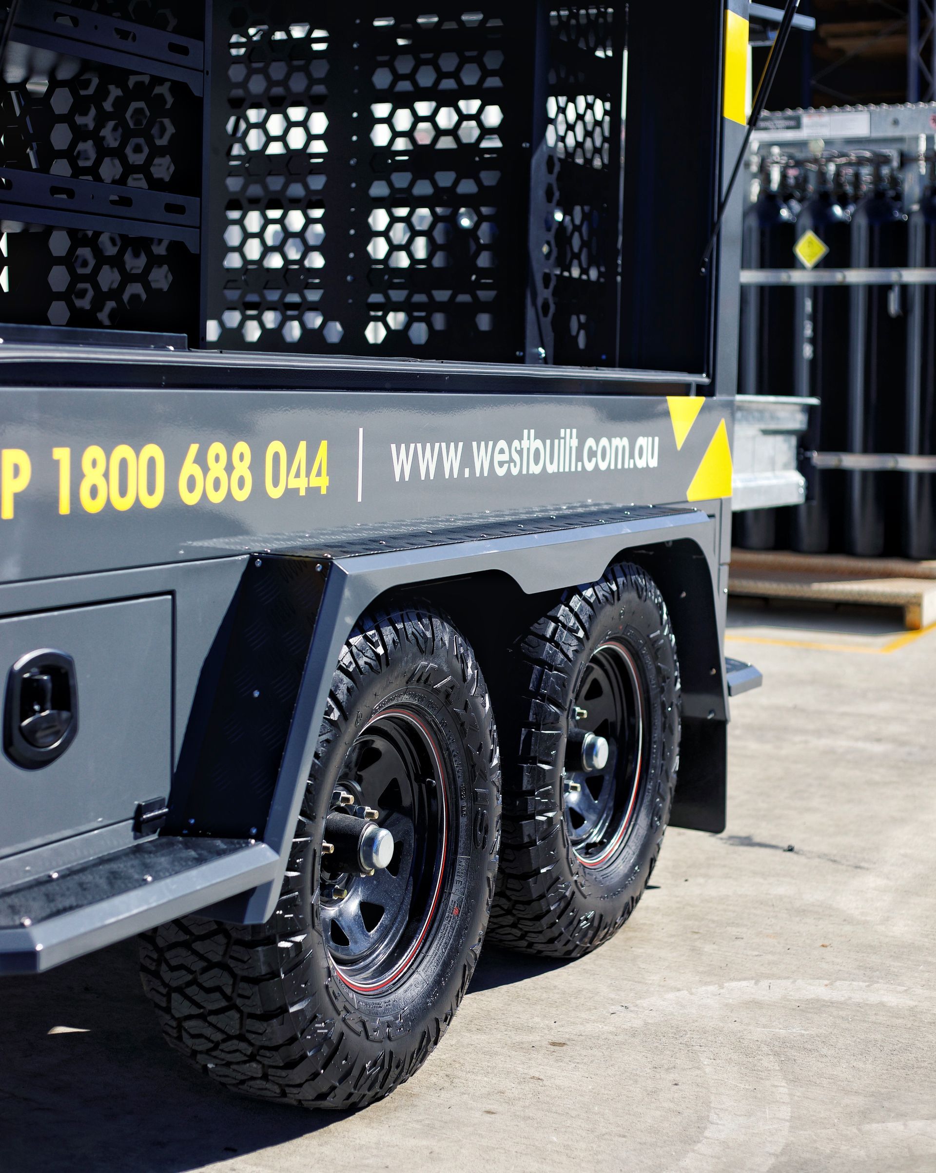 A low shot of the Builders Trailer tandem axle tyre set up, mudguards and toolboxes.
